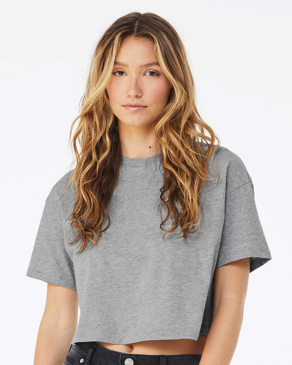 Woman wearing a gray t-shirt against a white background